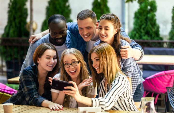 group of people looking at a phone